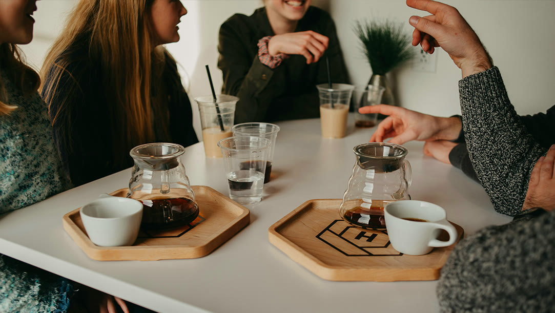 Writers talking around a table over coffee